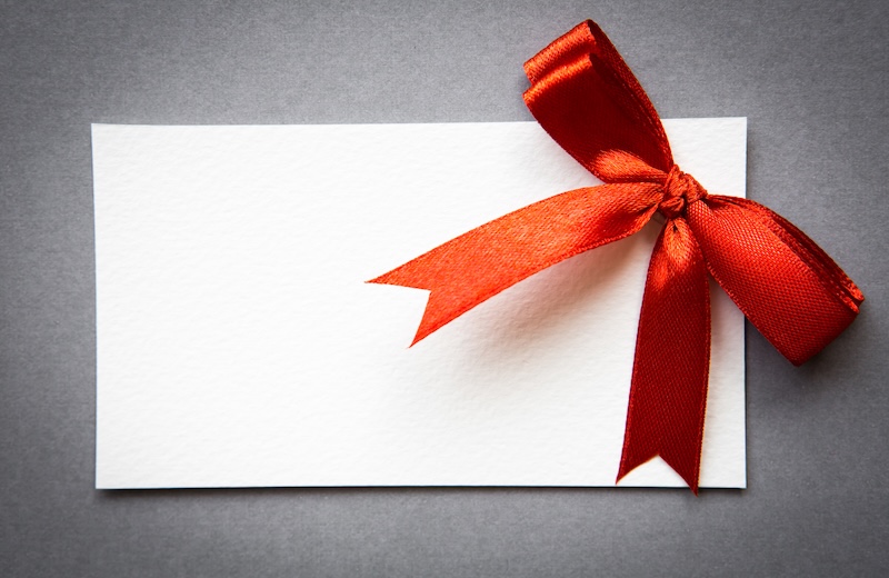 Presnetkort med röd rosett